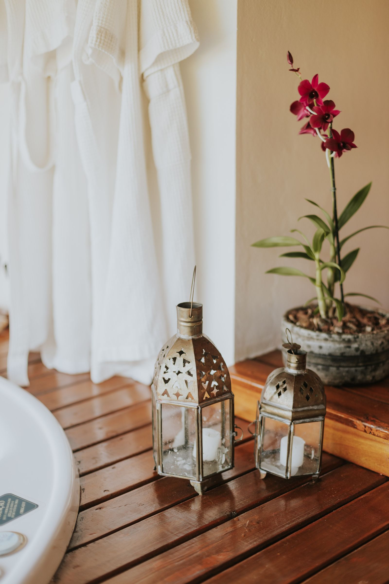 Candle lanterns and an orchid in a quiet spa corner
