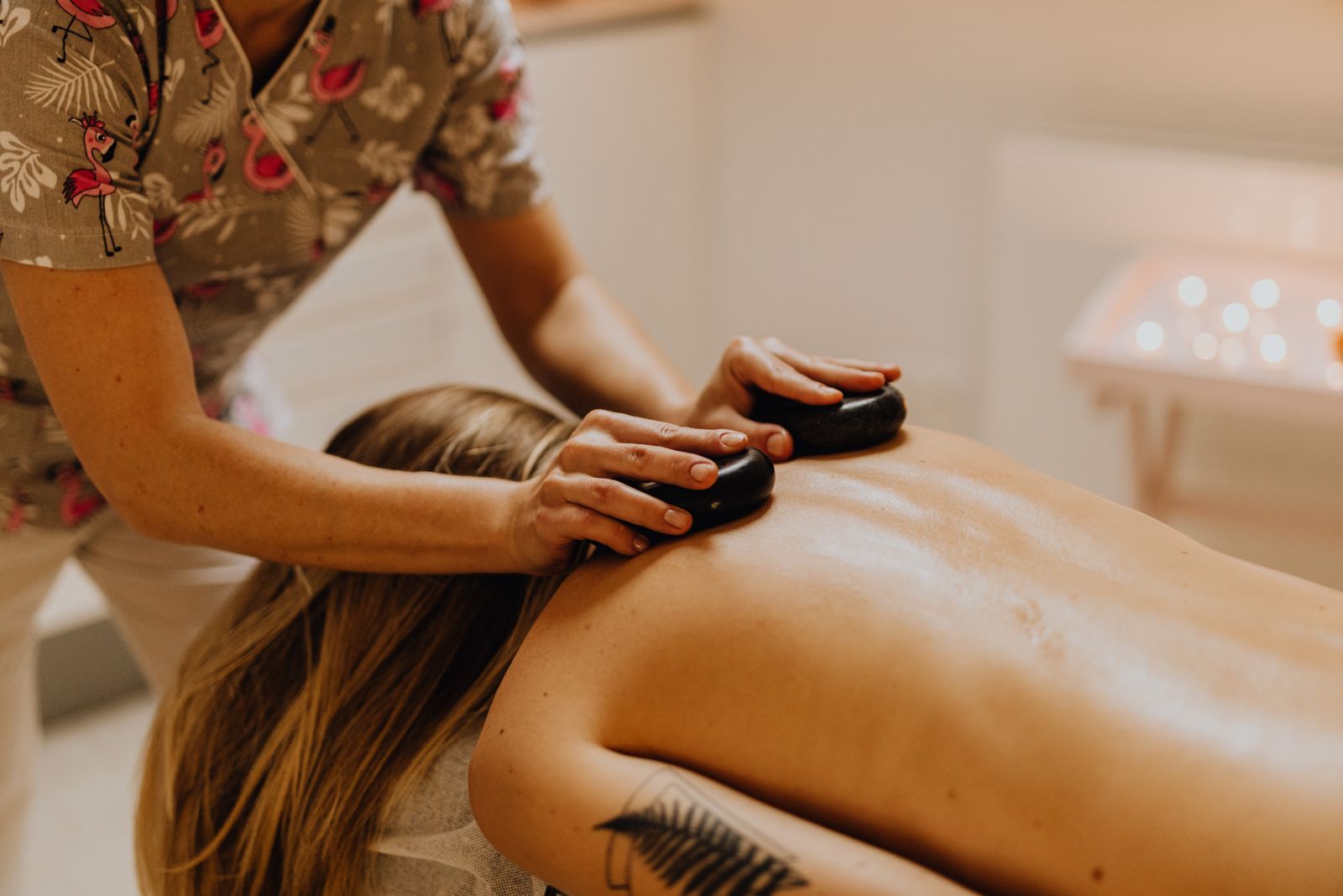 A serene hot stone massage session promoting relaxation and wellness in a spa setting.