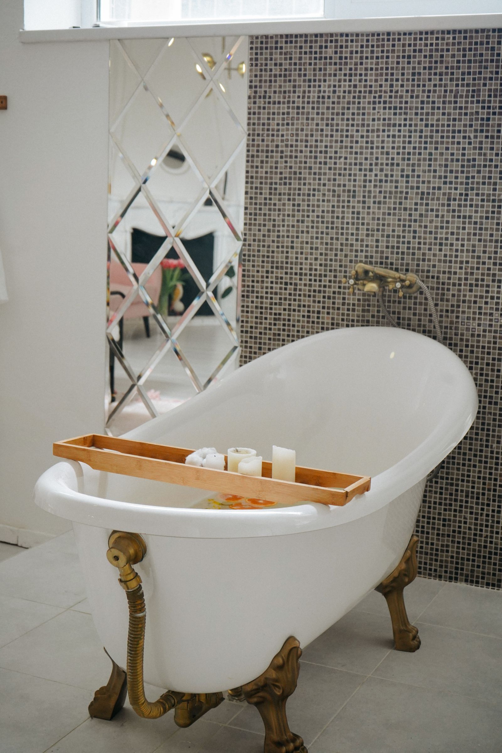 Candles and a freestanding bath in a calm spa setting